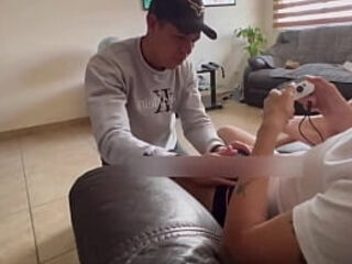 My stepbrother gives me a blowjob while I play PlayStation